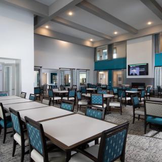 A spacious, modern dining area with neatly arranged tables and chairs.