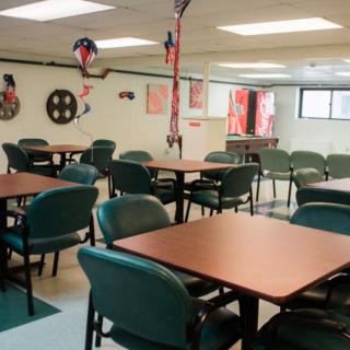 An empty cafeteria room with decorated tables and chairs.