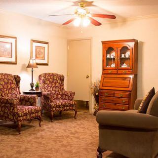 A cozy living room with comfortable seating and warm lighting.