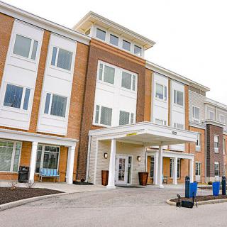 A modern multi-story building with a prominent entrance.