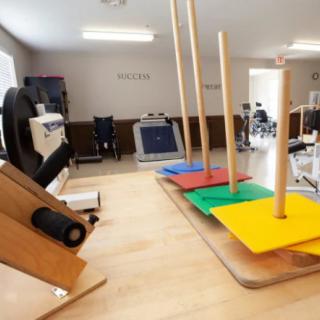 A physical therapy room equipped with various exercise equipment for rehabilitation.