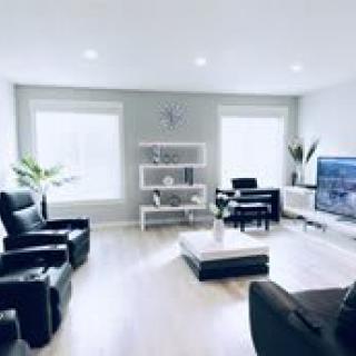 A bright and modern living room with minimalist decor and comfortable seating.