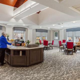 A spacious and well-lit lobby with a reception desk and seating area.