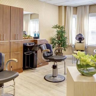A modern hair salon interior with stylish chairs and equipment.