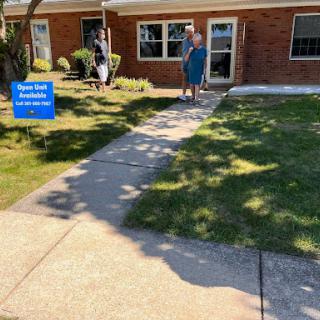 A sunny day at a real estate open house with visitors exploring the property.