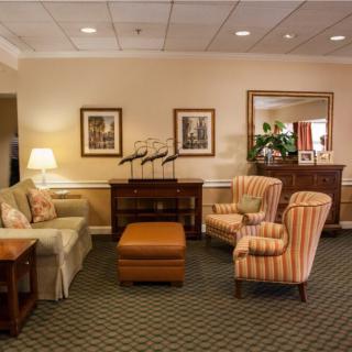 A cozy living room featuring comfortable seating and warm decor.