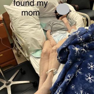 A person resting in a hospital bed.