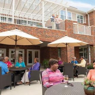 Residents enjoying a sunny day outdoors at a community gathering place.