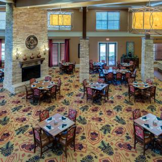 Elegant dining area with neatly arranged tables and a cozy fireplace.