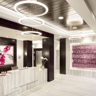 A modern reception area featuring contemporary art and elegant lighting fixtures.