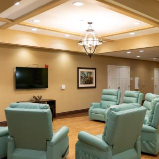 A cozy living area with recliners and a television.
