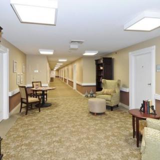 A well-lit hallway with seating areas and decor.