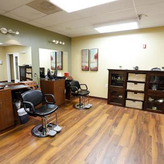 Interior of a hair salon with chairs and mirrors.