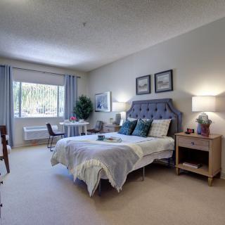 A modern and spacious bedroom with stylish decor and a comfortable bed.