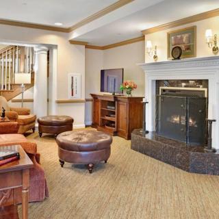 A cozy living room featuring a warm fireplace and comfortable seating.