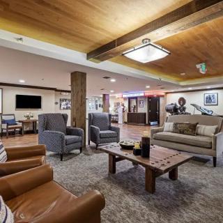 A modern living room with comfortable seating and wooden accents.