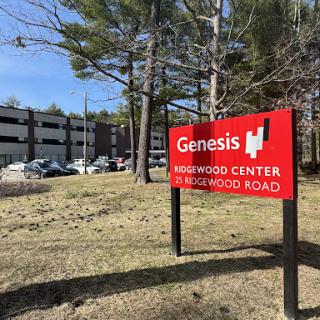 Sign for Genesis at Kirkwood Center on Brookwood Road, with a view of the surrounding area.