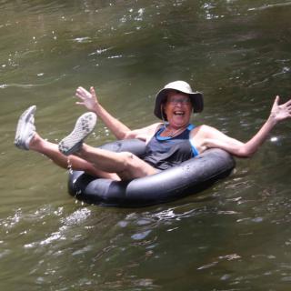 A person enjoying a relaxing float down the river in an inner tube.