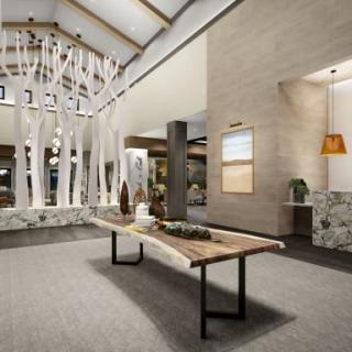 A modern lobby with stylish wooden decor and contemporary design elements.