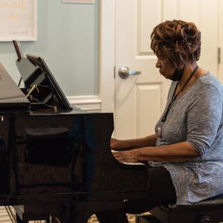 A woman playing the piano indoors.
