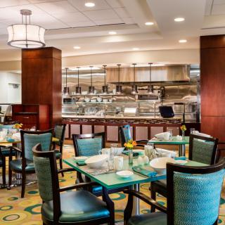 An elegant restaurant interior with neatly arranged tables and chairs.