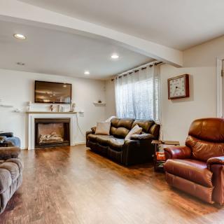 A cozy living room with comfortable seating and a fireplace.