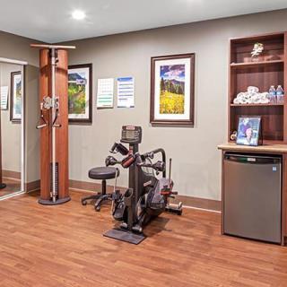 A small fitness room equipped with exercise machines and essentials for workouts.