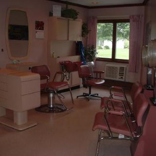 Interior of a hair salon with chairs and mirrors.