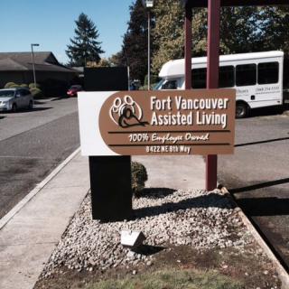 Sign for Fort Vancouver Assisted Living near a parking area.
