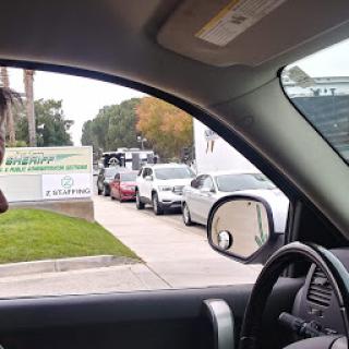 A view from inside a vehicle showing a line of cars on the road.