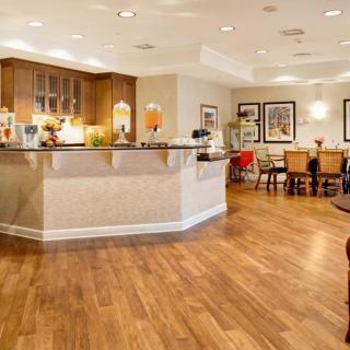A modern kitchen and dining area with wooden flooring and stylish decor.