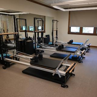 A serene Pilates studio equipped with multiple reformers for fitness training.