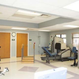 A well-equipped rehabilitation and physical therapy room with various exercise machines.