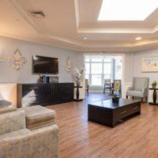 A modern living room with stylish furniture and wooden flooring.