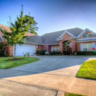 A suburban house with a well-maintained front yard and driveway.