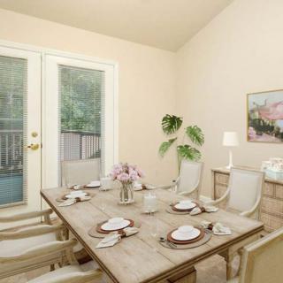 A stylish dining room with a set table and elegant decor.