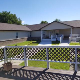 A residential building with a yard and a clear blue sky.