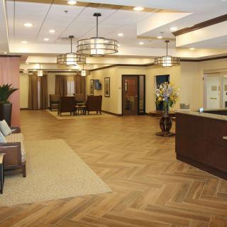 A modern lobby with elegant interior design, featuring comfortable seating and a reception desk.