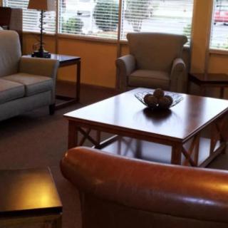 A cozy living room featuring sofas, chairs, a coffee table, and warm decor.