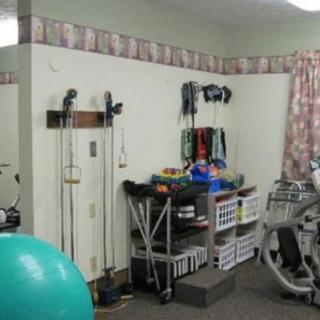 A well-equipped therapy room with various exercise equipment and tools.
