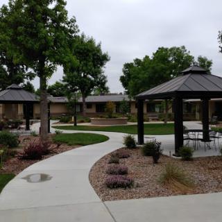 A serene park featuring well-maintained pathways, gazebos, and lush greenery.