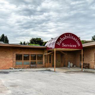 An exterior view of a building offering rehabilitation services with a clearly marked entrance.