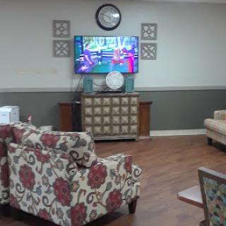 A cozy living room setup featuring comfortable furniture and a television.
