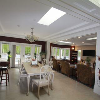 A modern open-plan living and dining area with elegant furniture and abundant natural light.
