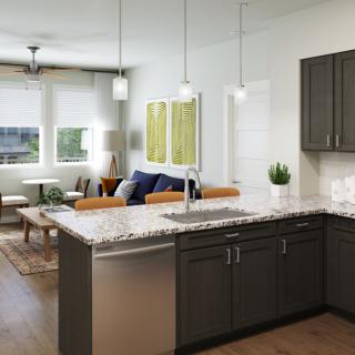 A modern open-concept kitchen and living room with dark cabinets, granite countertops, and pendant lighting.