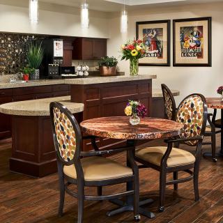 A cozy cafe interior featuring elegant tables, chairs, and decorative elements.