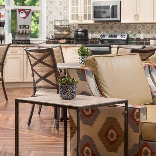 Modern kitchen and living area with an open floor plan, featuring stylish furniture and decor.