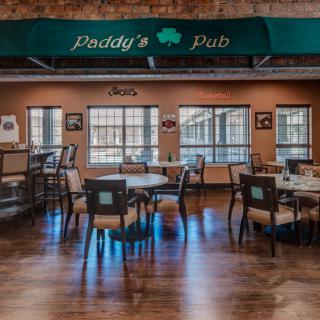 Interior view of a pub with tables and chairs arranged neatly.