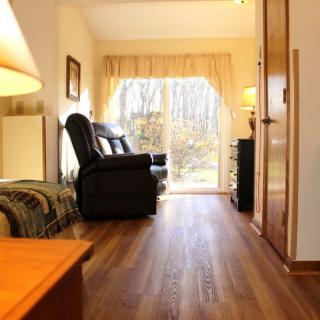 Cozy living room with hardwood floors and a bright window view.