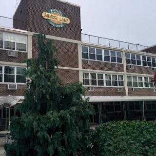 Exterior view of a restaurant building with a prominent sign.